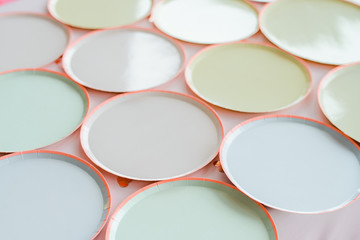 a variety of paper disposable plates of different colors