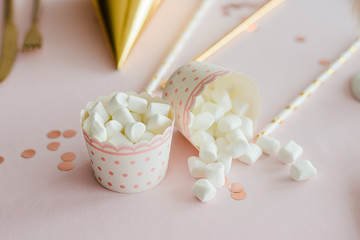 Cute birthday sweets marshmallow on party table in pink and gold colors