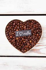 Roasted coffee grains forming heart. Coffee love and romantic concept.