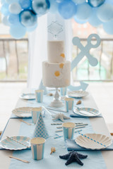 Decorative table setting in pastel colors with pink tablecloth, paper colorful dishes, cups, golden cutlery. birthday for girl, baby shower or hen party decoration. Ballon garland