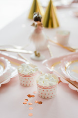 Delicious birthday sweets marshmallow on party table in pink and gold colors. Party table decoration. Selective focus.