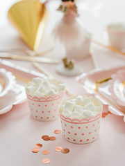 Fototapeta na wymiar Delicious birthday sweets marshmallow on party table in pink and gold colors