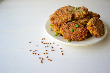 Vegan buckwheat and vegetable cutlets on a white background.