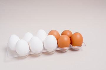 brown and white eggs in a shape located on a beige background