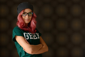 Geek girl with pink hair against abstract background