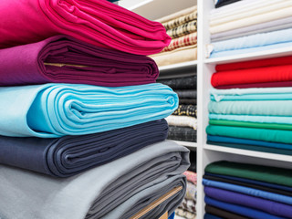 Collection of fashionable bright fabrics in close-up. Samples of different natural fabrics for...