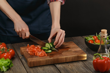 Woman cooking fresh vegetable salad. Female hands. Diet concept for healthy lifestyle with copyspace.