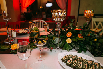 festive table decorated with leaves apricots grapefruits high glasses with gilding
