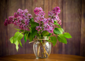 bouquet of beautiful blooming lilacs in a glass vase