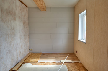 Empty room with wooden floor under reconstruction