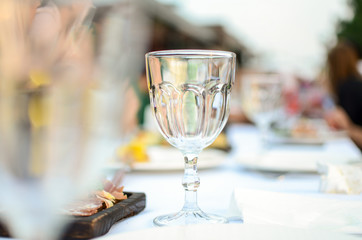 Empty glass stands on a table on a white tablecloth