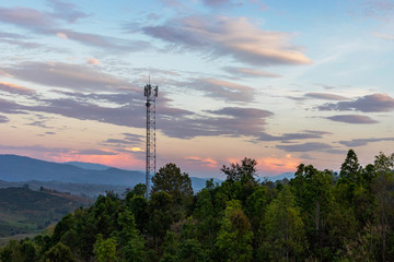 Telecommunication tower on top of the mountain with colorful sky