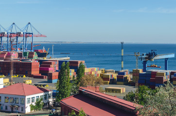 Port cargo crane loads a container onto a cargo ship