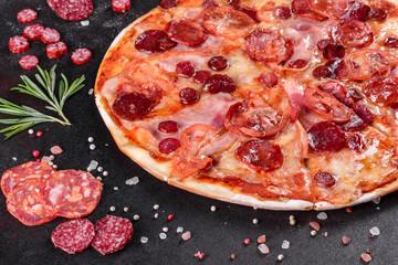 Pepperoni pizza with mozzarella cheese, salami, tomatoes, pepper and spices