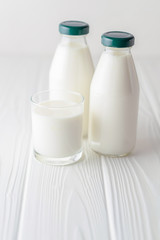 One glass bottle of homemade kefir on a white background with copy space