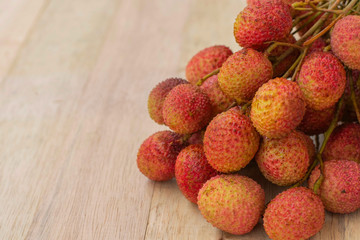 Lychee, fresh fruit placed on the wooden floor