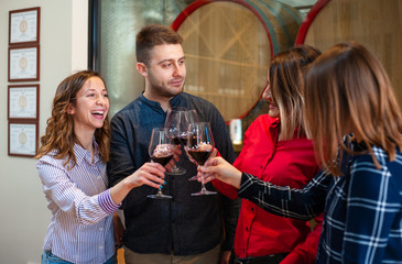 Friends celebrate their birthday at the local winery. Elegant glasses with homemade quality wine