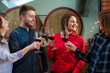 Friends celebrate their birthday at the local winery. Elegant glasses with homemade quality wine