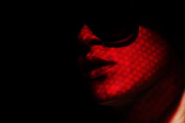 woman in red. Shadow. Dark background. Woman. Female. Sunglasses. 