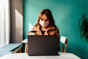 Business young woman working with computer laptop and wearing protection mask coughing be congested...