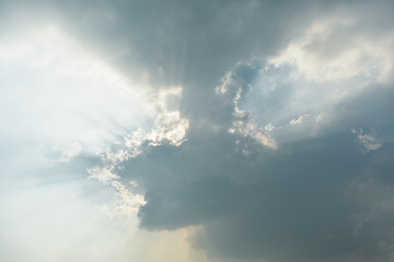 Naklejka na ściany i meble Beautiful cloud formation with rays of sun coming out from the clouds