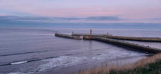 Fototapeta na wymiar view over Whitby beach toward the lighthouse