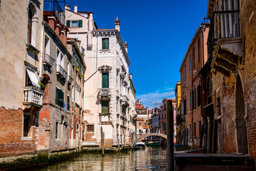 Fototapeta na wymiar Venetian canal, old buildings and medieval bridges .