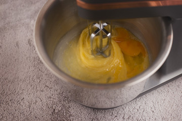Eggs are beaten with a mixer and sprinkled with salt.