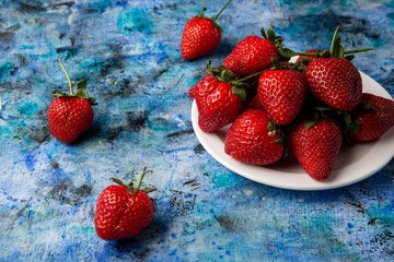 red strawberries on a blue background