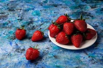 red strawberries on a blue background