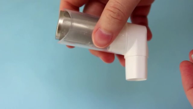 World Asthma Day May 5.anti-asthma inhaler on a blue background
