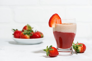 sweet strawberry yoghurt milkshake on white table