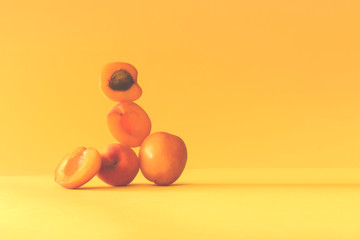 apricot still life on a yellow background