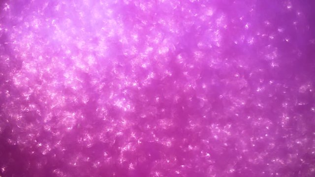 Purple glitter background with sparkling texture. Beautiful purple shimmering light.