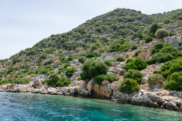 Obraz premium Ruins of sunken ancient city of Dolichiste on the northern part of the Kekova Island. Devastating earthquake in the 2nd century AD