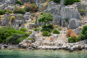 Fototapeta na wymiar Ruins of sunken ancient city of Dolichiste on the northern part of the Kekova Island. Devastating earthquake in the 2nd century AD