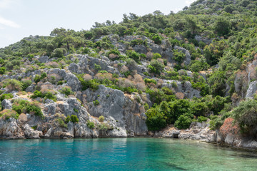 Naklejka na ściany i meble Ruins of sunken ancient city of Dolichiste on the northern part of the Kekova Island. Devastating earthquake in the 2nd century AD