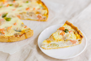 smoked salmon, Brussels sprouts and gorgonzola quiche tart, top view. Piece of homemade pie
