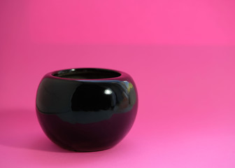Black bowl on pink background