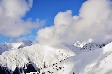 Fototapeta na wymiar snowy mountains in winter season on sunny day at high altitude