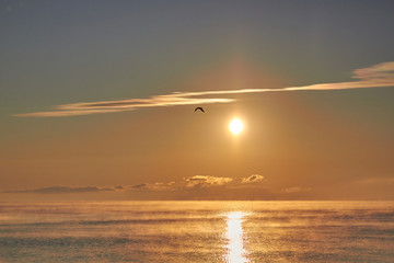 Dawn over the sea with clouds and fog