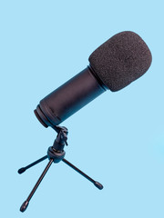 Studio microphone for recording over blue background.