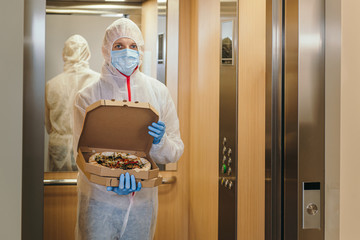 Safe pizza home delivery during virus outbreak and quarantine.