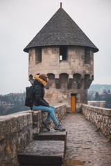 Young woman in a medieval castle, woman on vacation in Europe