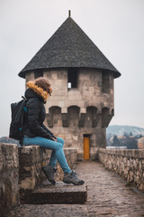 Fototapeta premium Young woman in a medieval castle, woman on vacation in Europe