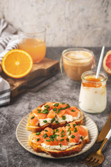 Cheese and salmon toasts, breakfast concept with coffee and freshly squeezed orange juice, healthy food.