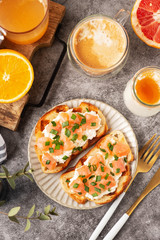 Cheese and salmon toasts, breakfast concept with coffee and freshly squeezed orange juice, healthy food.