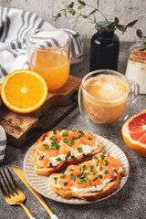 Cheese and salmon toasts, breakfast concept with coffee and freshly squeezed orange juice, healthy food.