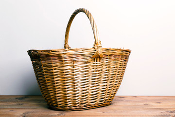 Large wicker basket on a wooden table
