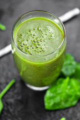 Freshly made spinach smoothie (close up; selective focus)